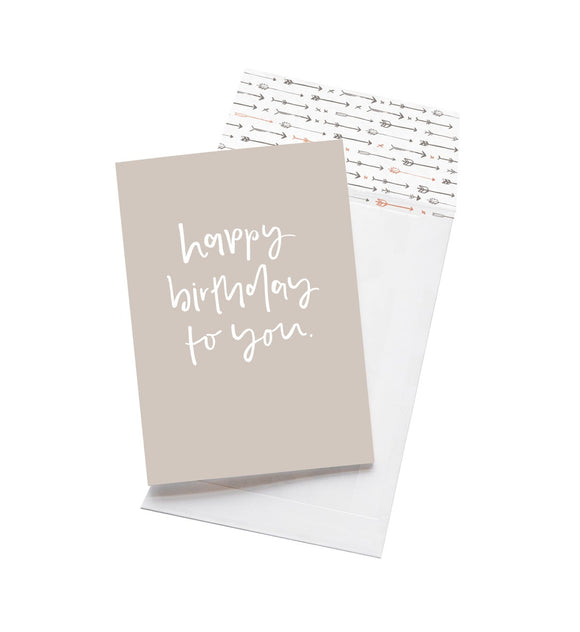 A light grey birthday card which reads 