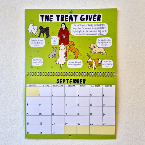 Calendar titled 'The Treat Giver' with illustrations of a person and dogs on a green background.