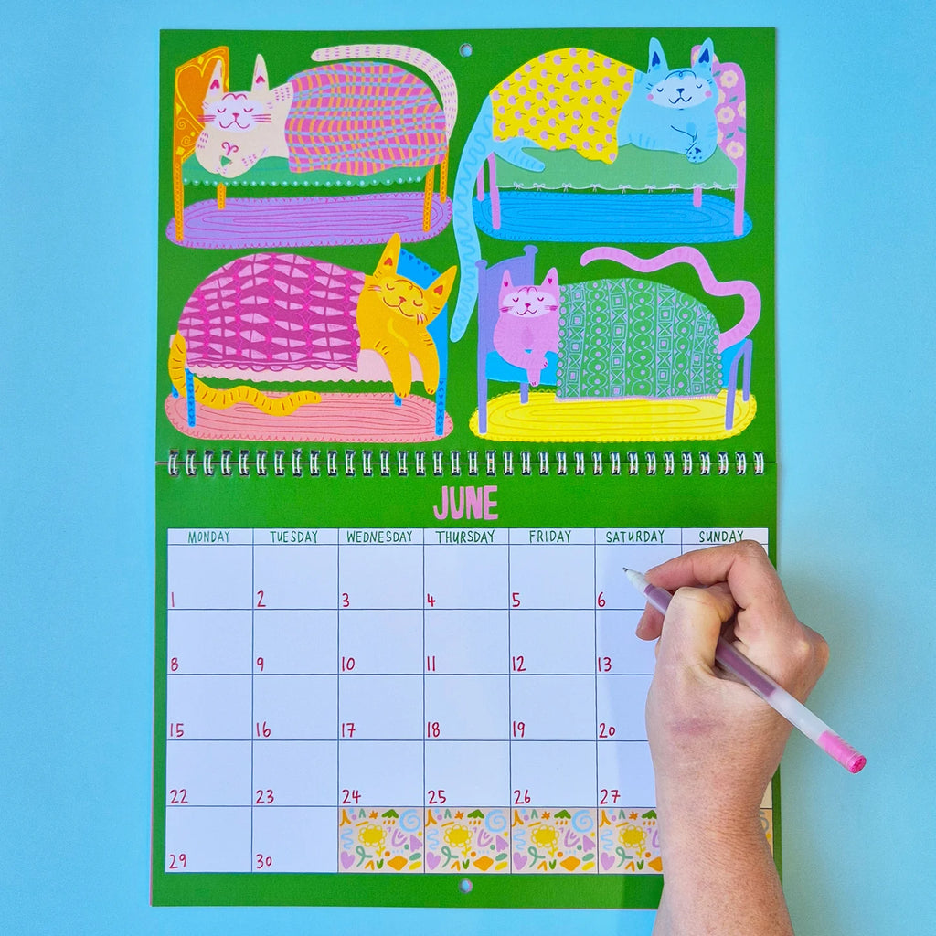 Calendar with colorful cat illustrations on a blue background