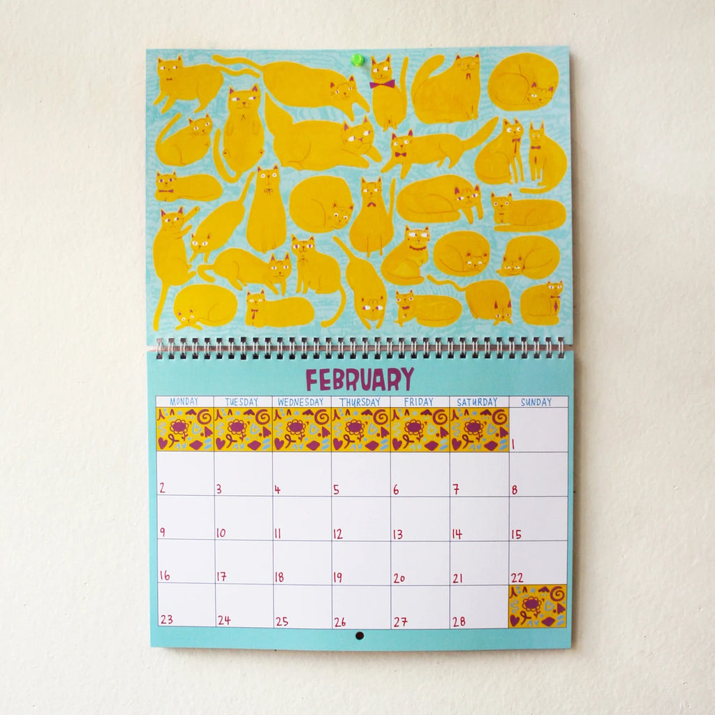 Calendar with yellow cat illustrations on a light blue background