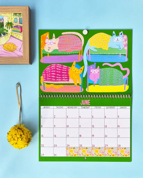 Calendar with colorful cat illustrations on a blue background