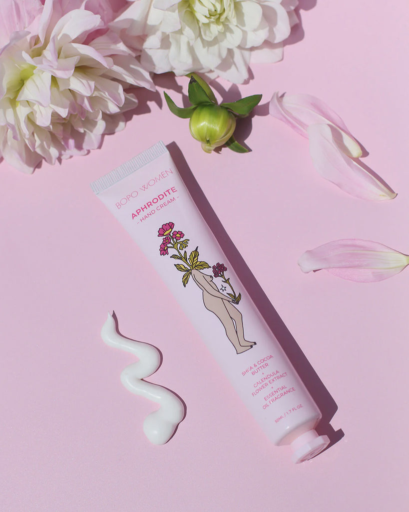 Hand cream with floral design on a pink background