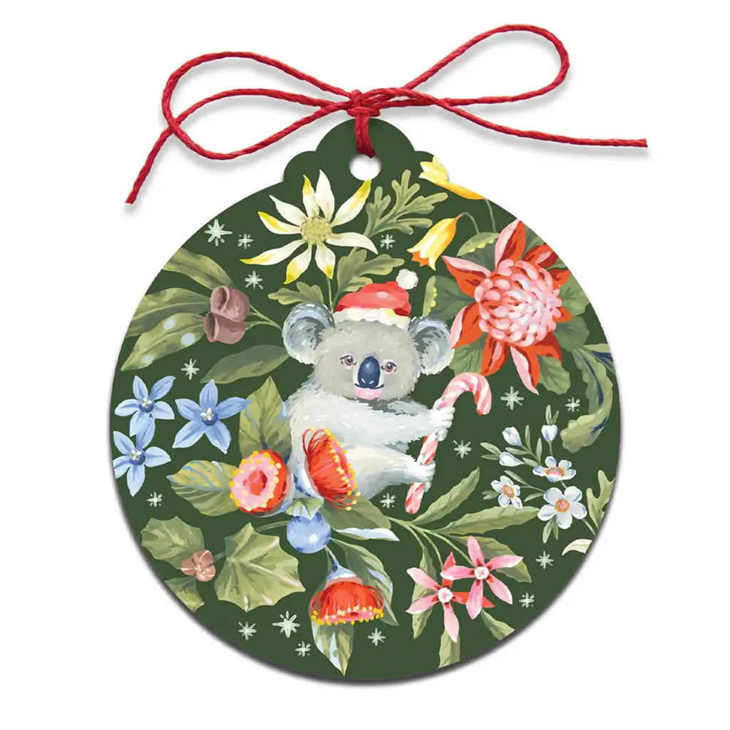 Decorative ornament with a koala, Santa hat, and candy canes on a floral background.