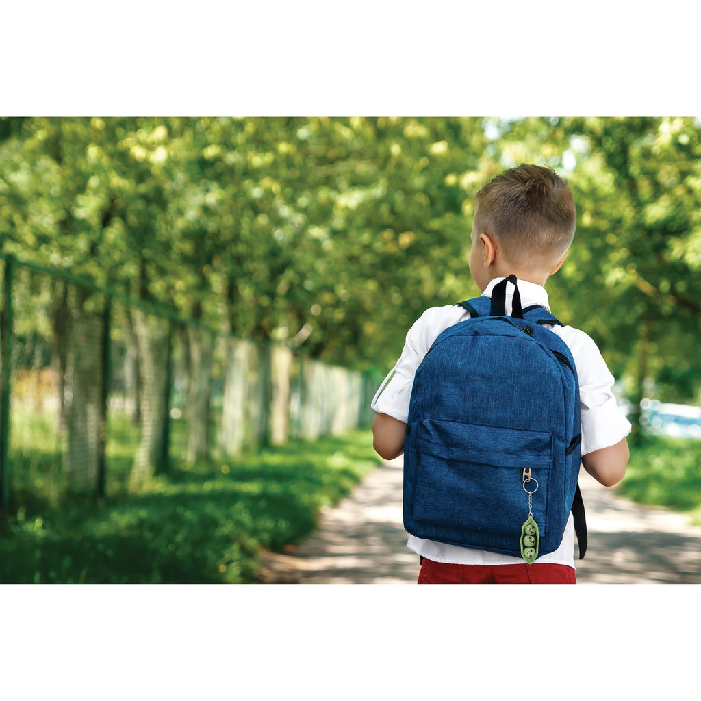 Child with a blue backpack and pea keychain walking down a tree-lined path