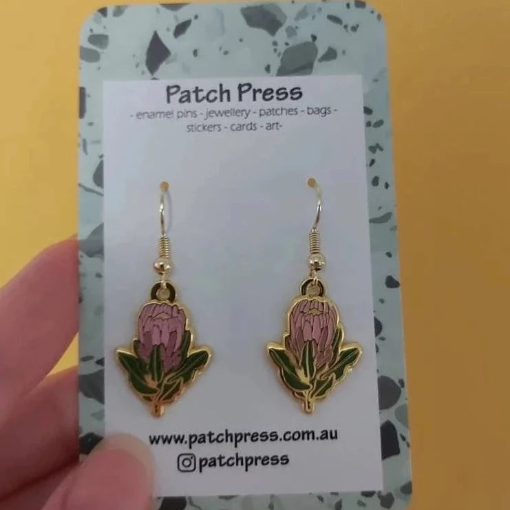 Patch press pink protea enamel dangle earrings at HYMC in Adelaide, South Australia.