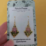 Patch press pink protea enamel dangle earrings at HYMC in Adelaide, South Australia.